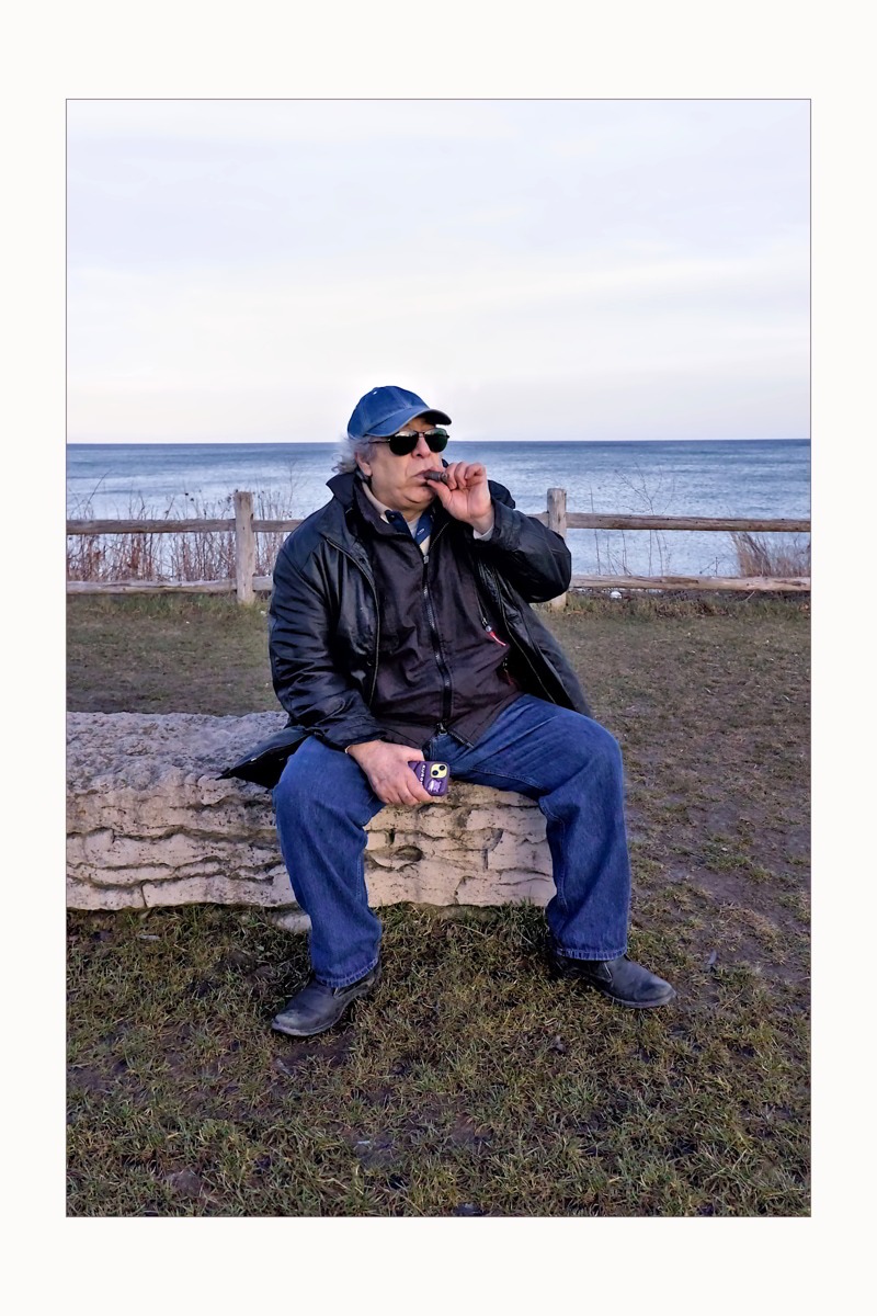 Mahmoud, accidental friend. Lake, horizon, cigar, stone. No story imposed — just presence witnessed.